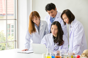 Four asian medical workers. Portrait of asian doctor. Chemists doing in the laboratory. young scientists with test and research in clinical laboratory.