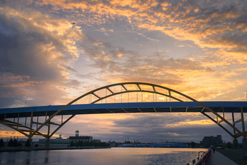 Sailboat going under Hoan Bridge in Milwaukee, Wisconsin at Sunset