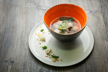 delicious noodle soup with mushrooms, meat, and nettle leaves