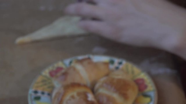 Girl cooking homemade pastery and lining it on a tray for Christmas.