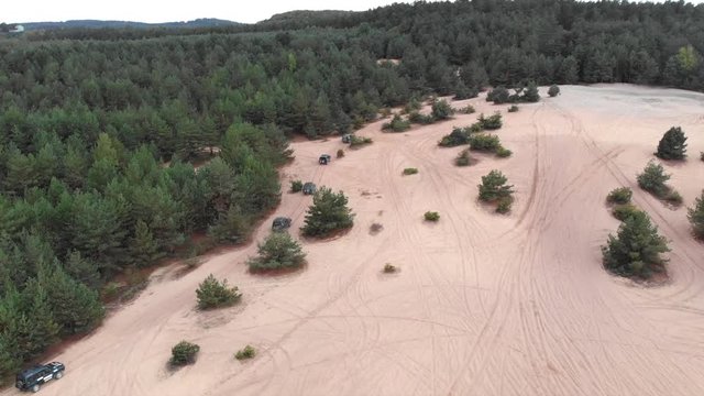 Several off-road vehicles driving through the desert
