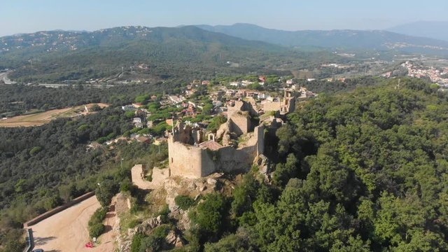 Beautiful landscape of the Palafolls Castle ruins on the top of the hill a sunny day. Catalonia Spain. Aerial view travelling