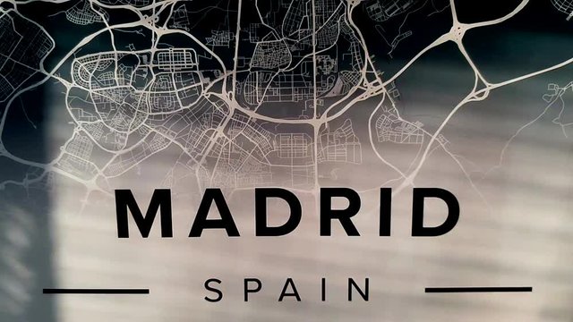 Madrid, Spain title with map revealed by sunshine