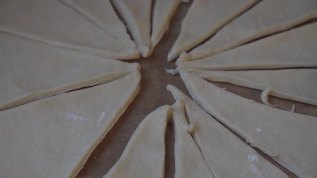 Girl cooking homemade pastery from sliced up dough.