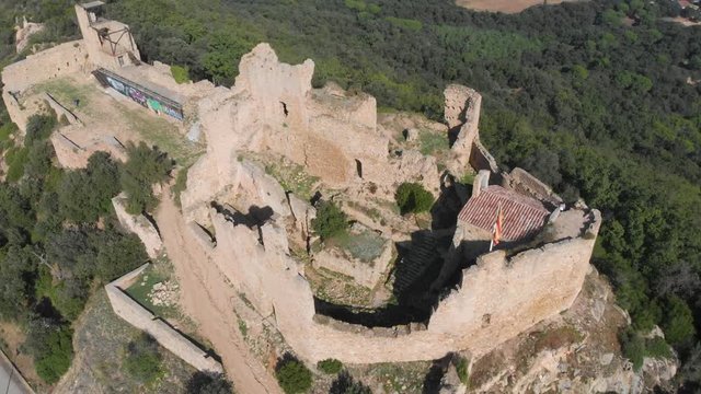 Beautiful view of the ruins of Palafolls Castle on a sunny day seen from above. Catalonia Spain. Aerial view travelling high angle shot