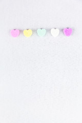 Obraz premium Conversation Hearts Line Up On A White Background