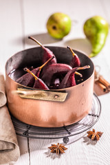 Tasty mulled wine with pears on white table