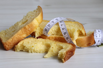 The concept of cut down one's carbohydrate intake. Bread and a tape measure.