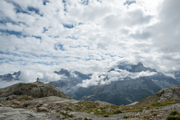 Naklejka na ściany i meble Lone figure looks over Mont Blanc massif, near Chamonix, France