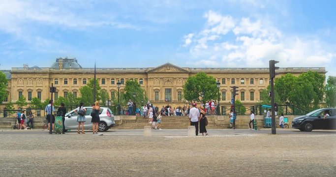 Palais du Louvre in Paris, France. People tourists walking in the street in front of the most important museum of Europe. Time lapse video