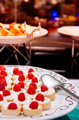 Raspberry tarts on white ceramic tray