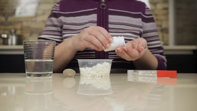 Woman drinking medicine bofore eating diet cheese. Strict medical diet. Pills. Digestive Disorders and Gastrointestinal Diseases. Health problems
