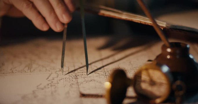 Different views of a vintage 1850 mapmaker using a compass divider going over a map taking notes