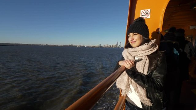 Young and beautiful woman on a ferry in New York