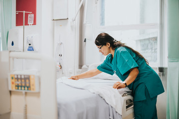 Nurse making the bed at a hospital