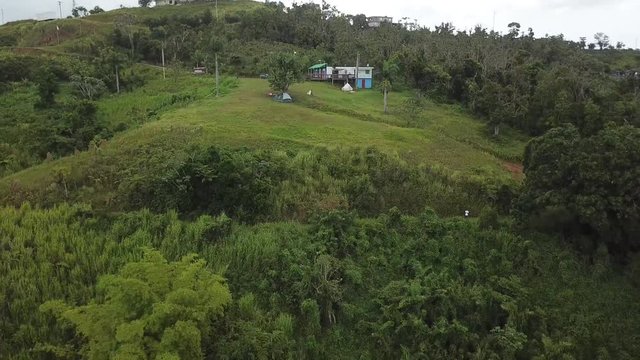 AERIAL: pulling away from some housing on the mountain tops of Utuado, Puerto Rico.