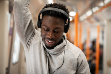 Happy man riding the underground train