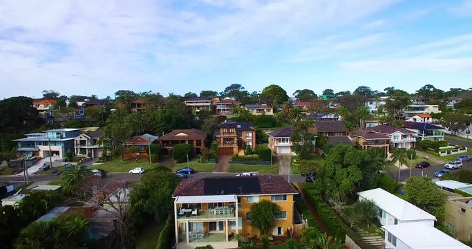 houses at calm beach environment, revealing backwards