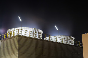 Industrial cooling tower at night