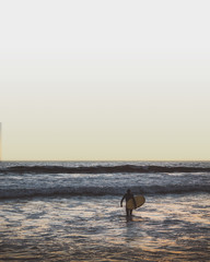 silhouette of surfer on beach