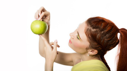 Fototapeta na wymiar funny redhead woman holding green apple. healthy lifestyle concept