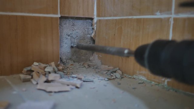 Workers jack hammer destroys concrete wall , Close up
