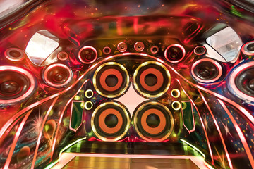 colorful lights of stereo and speakers in car in the night - obrazy, fototapety, plakaty