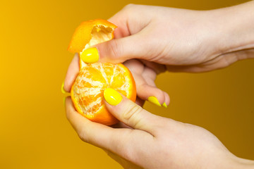 peeling a fresh mandarin orange