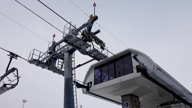 Gudauri ski lift station in action during the month of December in a foggy and snowy morning.