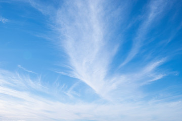 Blue sky background with white clouds.