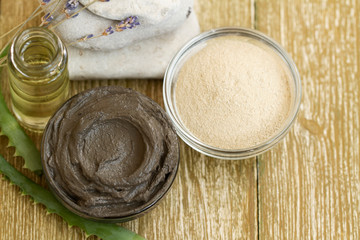 Preparing cosmetic mud mask with aloe vera, lavender and essential oil. facial clay powder with spa products. Natural cosmetics for home or salon treatment. white and black cosmetic claytop view