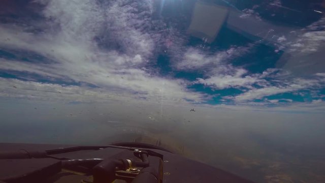 Fighter jet following the figher jet in the sky, beautiful flying in blue sky and clouds,captured from cockpit with gopro CAM, cockpit mirror is a bit dusty, sun is at the front of the jet