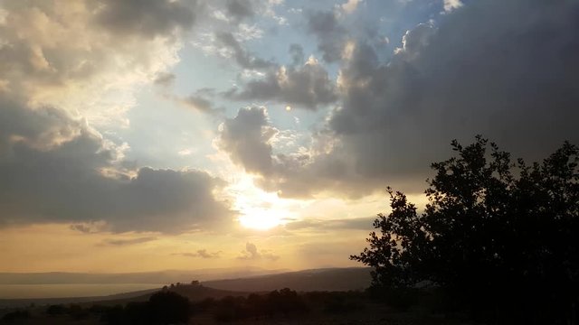 Beautiful Sunset on Huge Valley whit Trees And Big Lake and Mountains.
