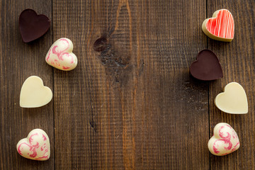 Heart-shaped confection for Valentine's day on dark wooden background top view space for text