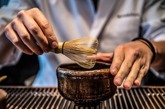 Man preparing matcha tea with bamboo&nbsp;chasen