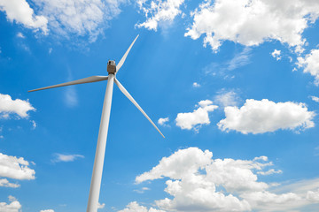 The wind generator is in bright cloudy sky. Eco energy concept.