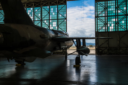 American Military Bomber Aircraft With Bombs Parked In Airport Base Hangar Ready For Flight Attack