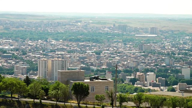 Contrasting between high rise apartments and areas of bushland at the foot of the mountains near Tabriz, Iran.
