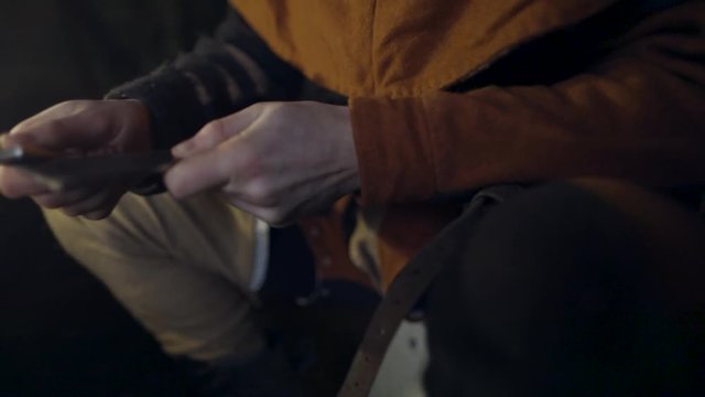 Grinding a knife in medieval setting.
