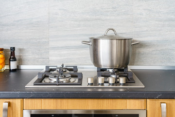 Metal Pot on induction hob in modern kitchen. modern kitchen pot cooking induction electrical stove...