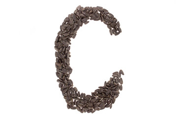 Alphabet from black sunflower seeds isolated on white background