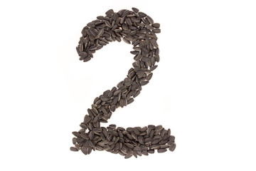 Numerals from black sunflower seeds isolated on white background.