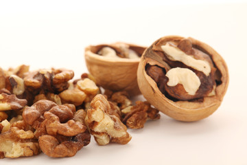 Fototapeta na wymiar A pile of peeled walnuts at white background 