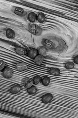Scattered coffee beans on a wooden table. Top view