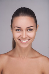 brunette woman with glad smile showing her perfect teeth posing