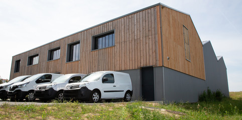Loading delivery vans in front of cargo doors warehouse for delivery