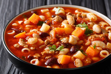 Delicious Italian fagioli soup with vegetables, ditalini pasta and ground beef closeup in a bowl. horizontal