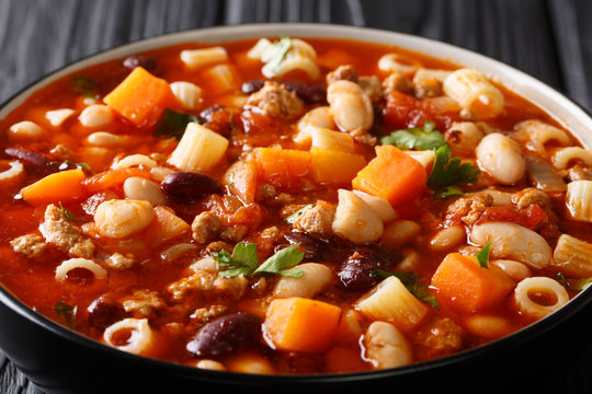 Delicious Italian Pasta fagioli soup with vegetables and ground beef close-up in a bowl. horizontal