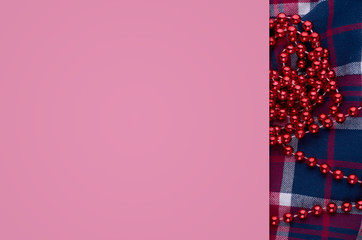 New Year composition with cotton textine and beads. Christmas concept background. Flat lay, top view of festive still life