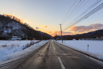 Beautiful Winter Landscape with Winter forest under the snow , powder snow on a road in, Hokkaido Japan